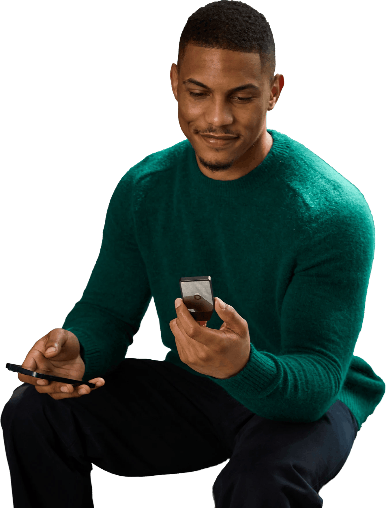 Man holding a Trezor Safe 7 hardware wallet and a smartphone